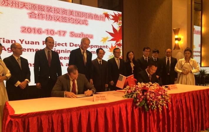 Mike Preston, executive director of the Arkansas Economic Development Commission (AEDC), signing MoU with Tang from Suzhou Tianyuan Garments company. Courtesy: Government of Arkansas
